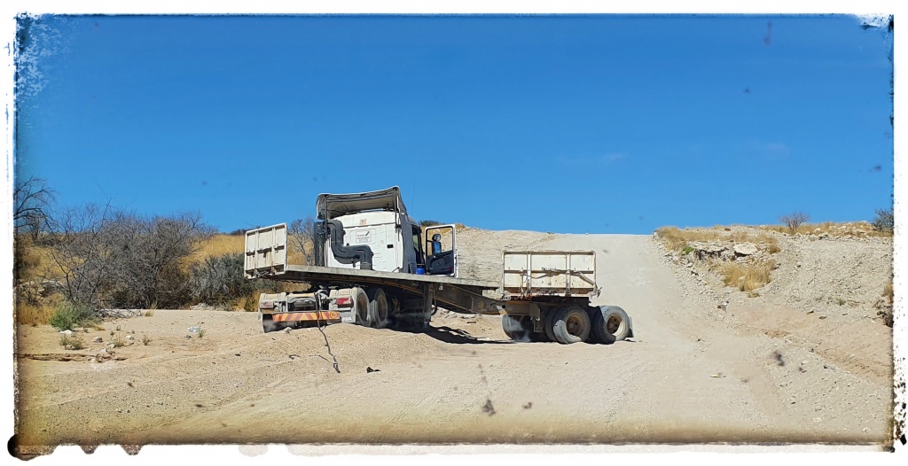 jack knived truck in dried river bed